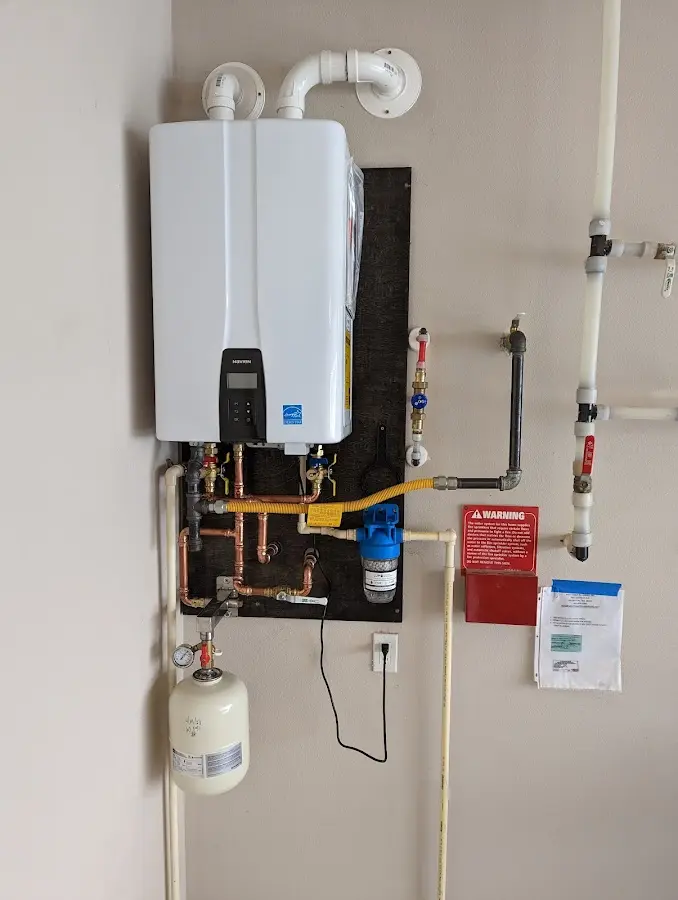 Professional plumber installing copper piping in a Brookside home